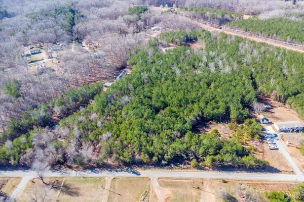 a view of a lake with large trees