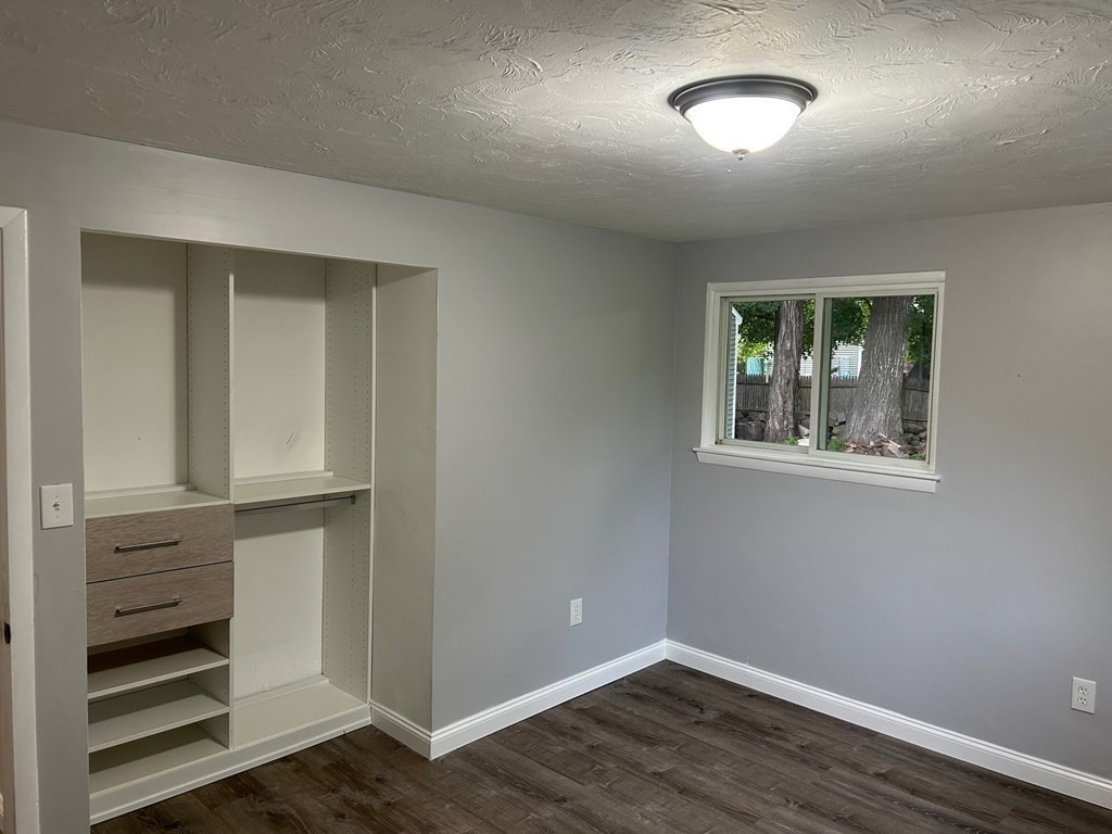 73 Brooks Street Maynard, MA 01754 - Photo 11 of 17 a view of an empty room with a window and wooden floor
