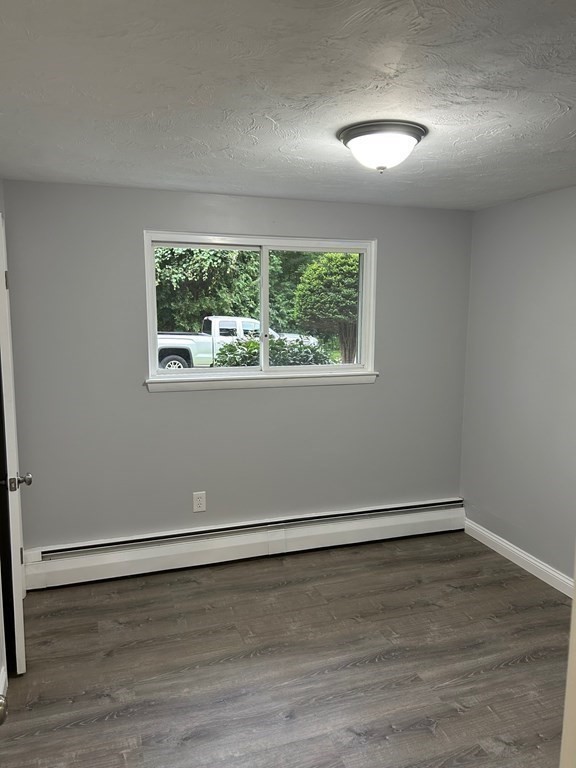 73 Brooks Street Maynard, MA 01754 - Photo 14 of 17 an empty room with wooden floor and windows
