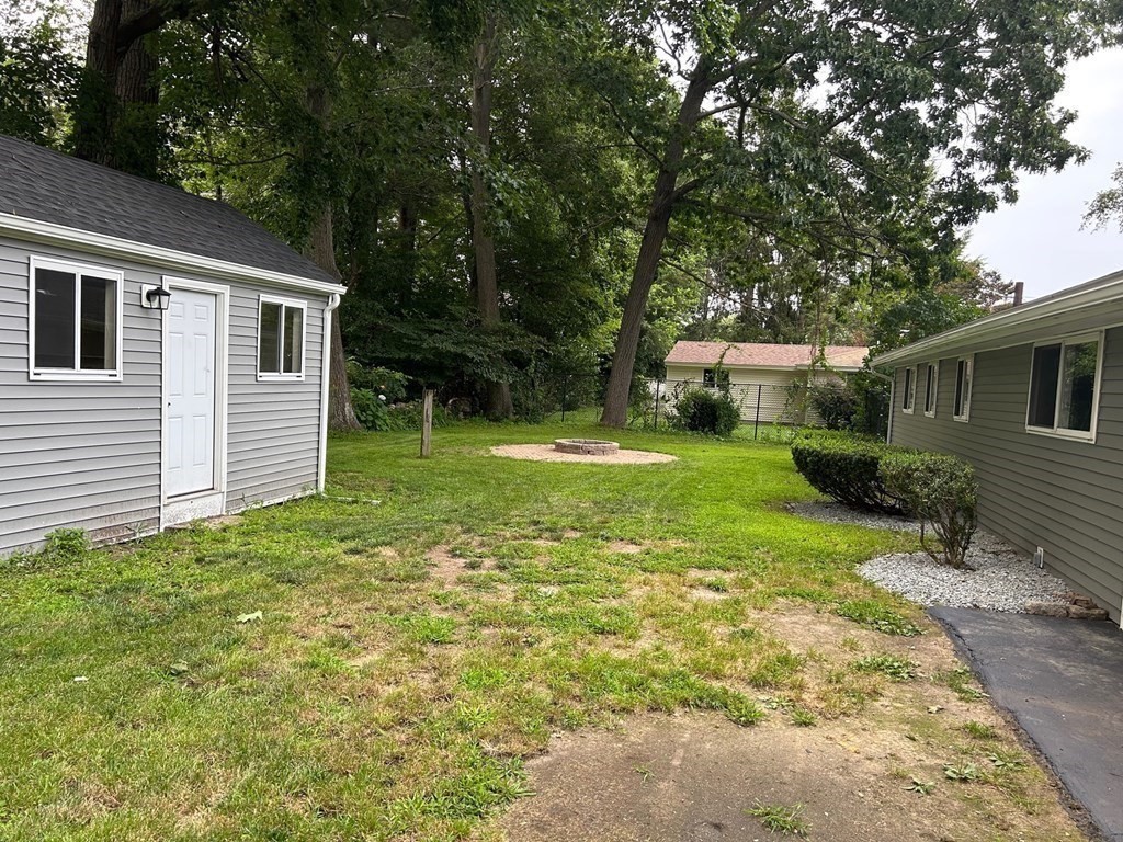 73 Brooks Street Maynard, MA 01754 - Photo 17 of 17 a view of a house with backyard and trees