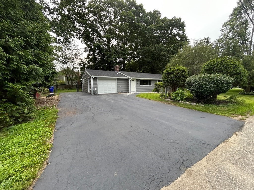 73 Brooks Street Maynard, MA 01754 - Photo 2 of 17 a front view of a house with a yard and garage