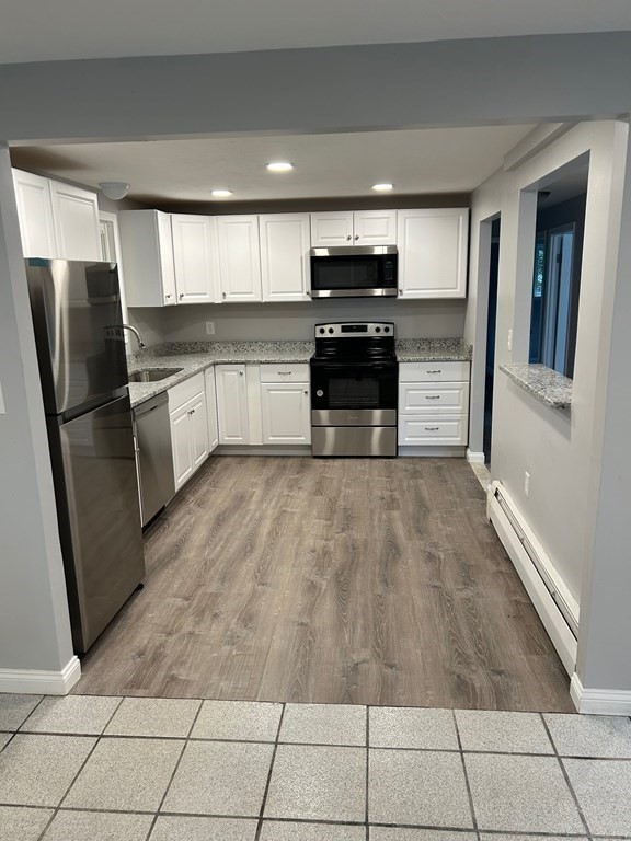 73 Brooks Street Maynard, MA 01754 - Photo 5 of 17 a kitchen with granite countertop a refrigerator and a sink