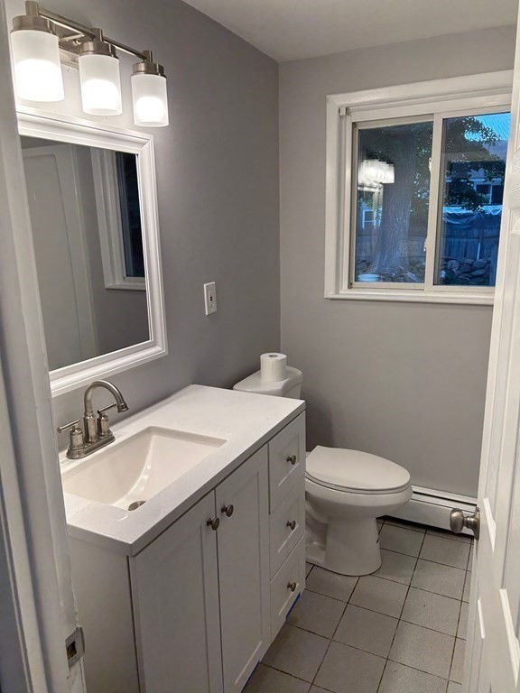 73 Brooks Street Maynard, MA 01754 - Photo 9 of 17 a bathroom with a toilet sink and mirror