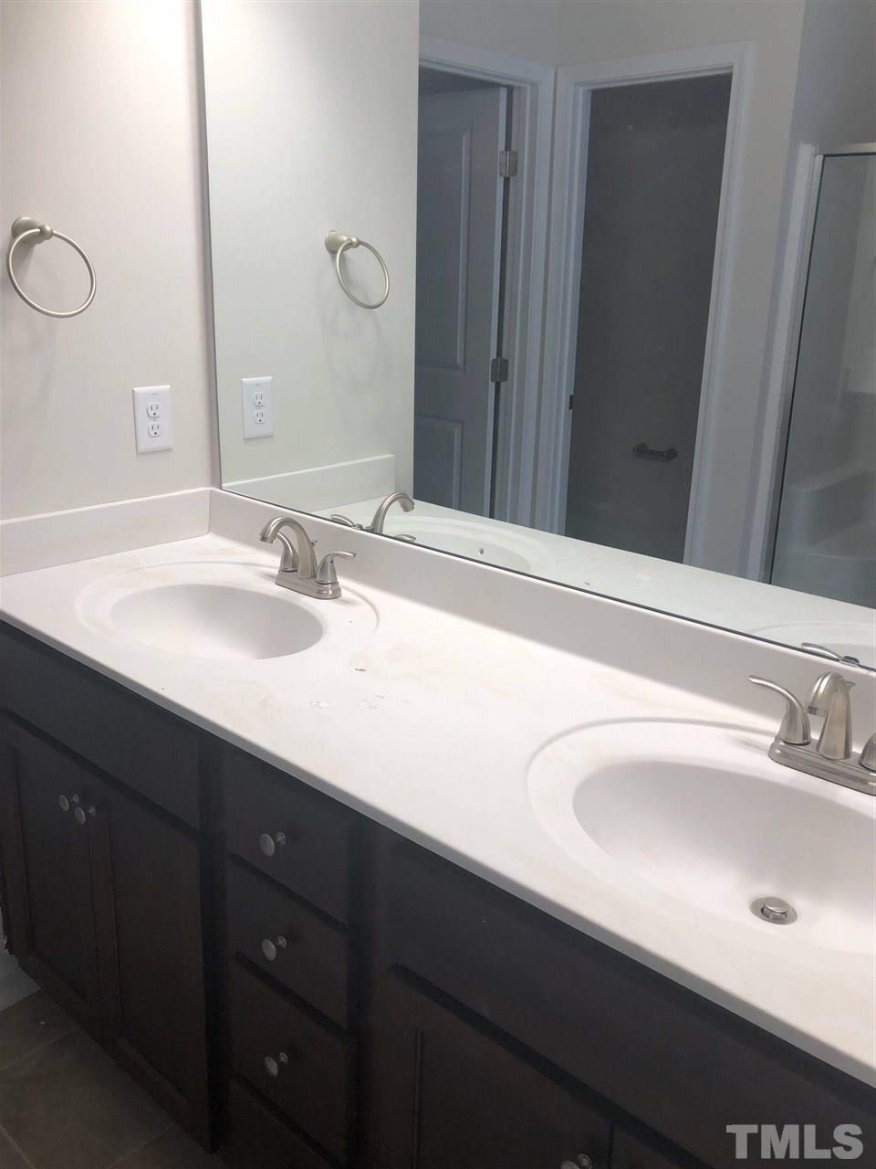 3627 Water Mist Lane, Unit 17 Raleigh, NC 27604 - Photo 13 of 17 a bathroom with a sink and a mirror