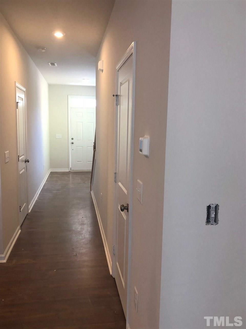 3627 Water Mist Lane, Unit 17 Raleigh, NC 27604 - Photo 7 of 17 a view of a hallway with wooden floor and a bathroom