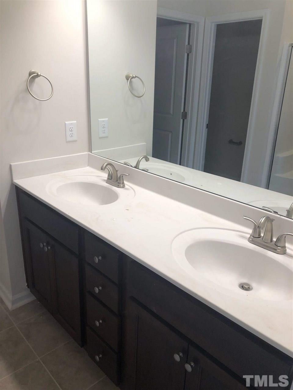 3627 Water Mist Lane, Unit 17 Raleigh, NC 27604 - Photo 9 of 17 a bathroom with a double vanity sink and a mirror