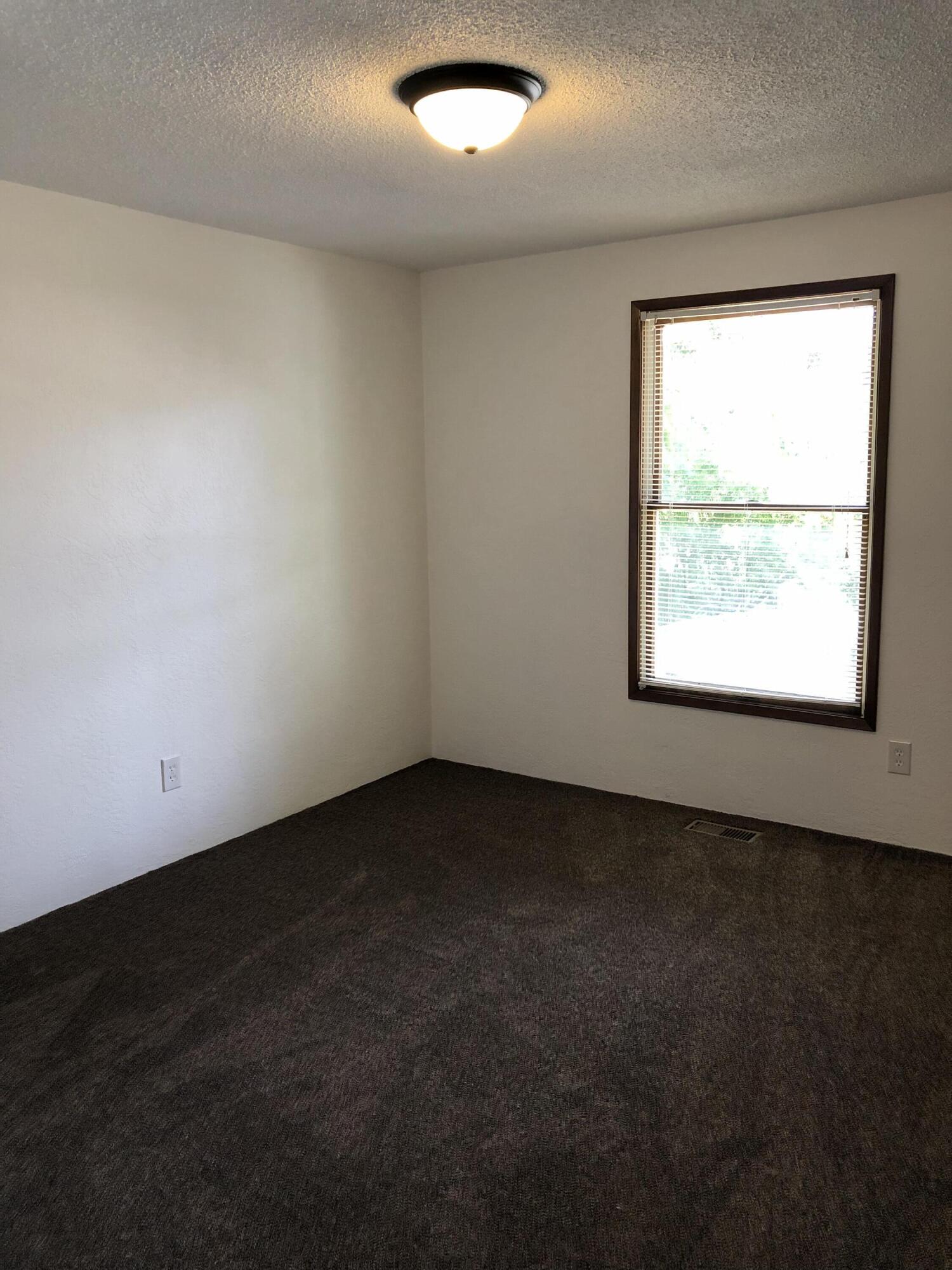 1600 Spring Street Medford, OR 97504 - Photo 32 of 55 Bedroom 2 w/ new carpet & lighting