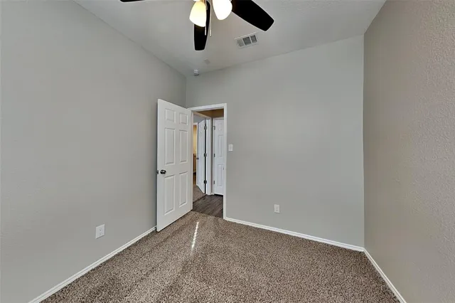 an empty room with ceiling fan