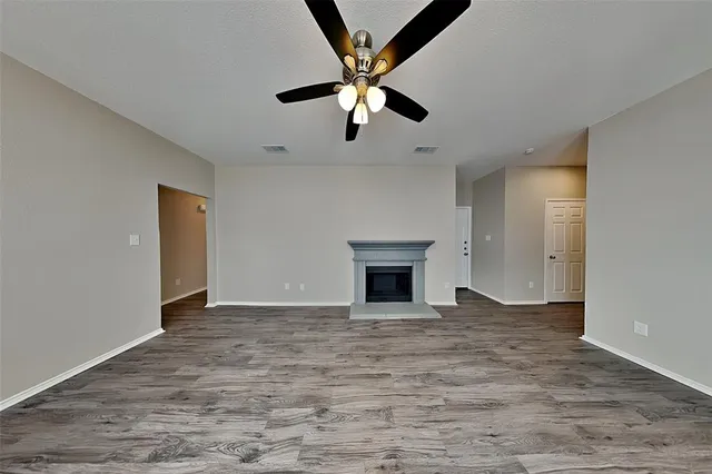 a view of an empty room with a ceiling fan