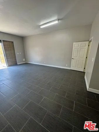 a view of an empty room and a bathroom