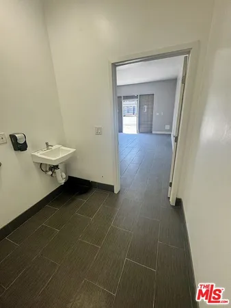 a view of a room that has a bed and a table in it