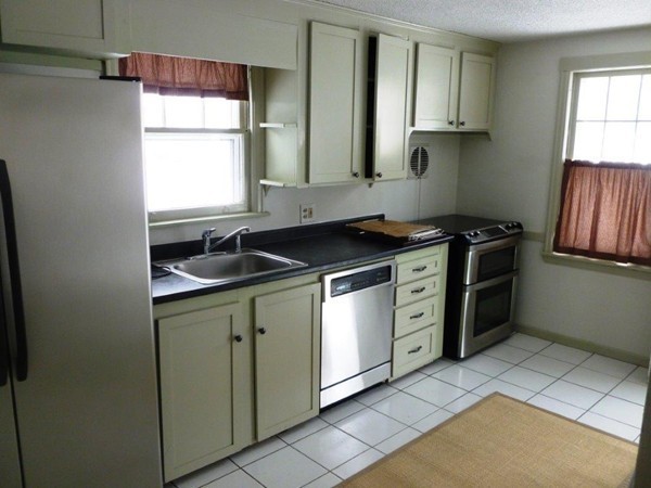 84 Mayflower Road Springfield, MA 01118 - Photo 4 of 14 a kitchen with stainless steel appliances granite countertop a sink stove and cabinets