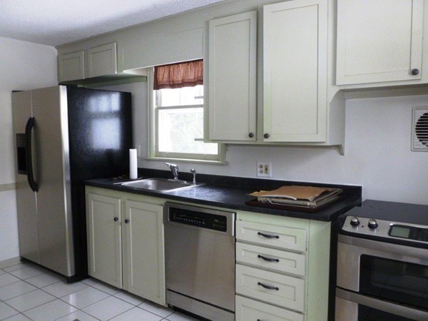 84 Mayflower Road Springfield, MA 01118 - Photo 5 of 14 a kitchen with appliances cabinets and a window