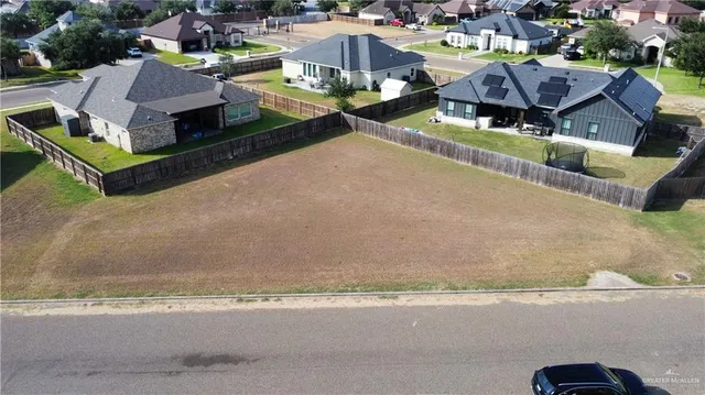 a aerial view of a house with a garden and lake view