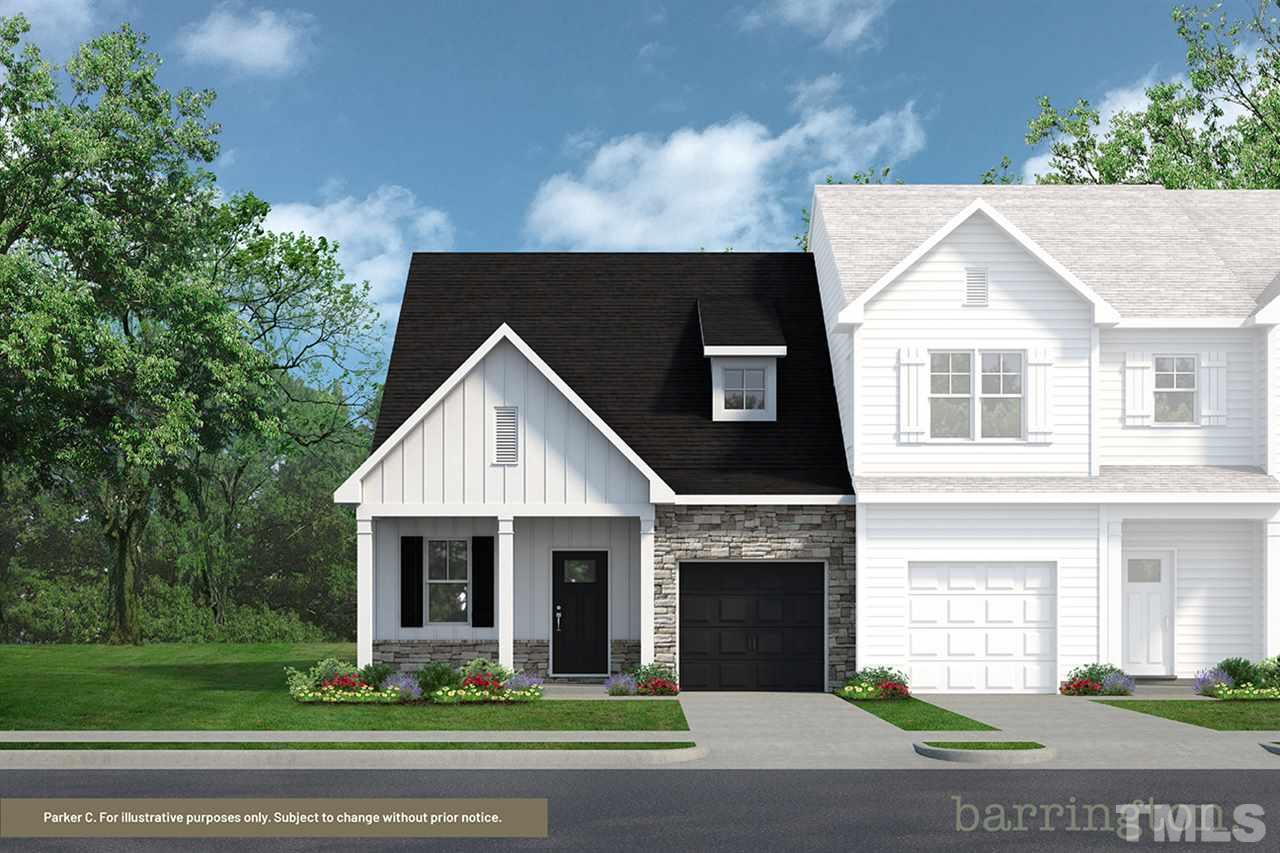 768 Putney Hill Road Zebulon, NC 27597 - Photo 1 of 10 a front view of a house with a yard and garage