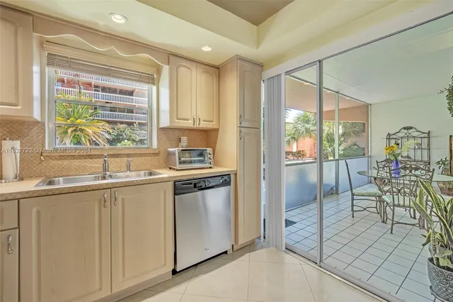 a kitchen with granite countertop a stove and white cabinets