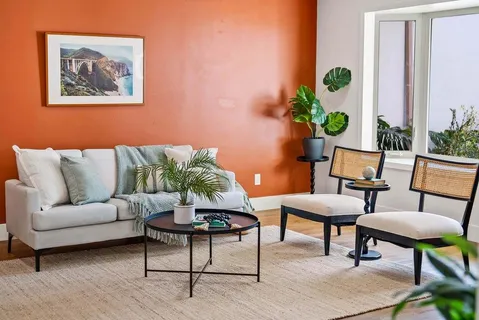 a living room with furniture potted plant and window