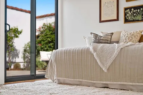 a spacious bedroom with a bed and a window