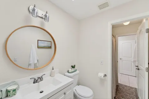 a bathroom with a toilet a sink and a mirror