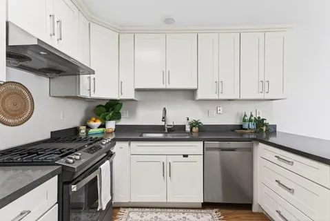 a kitchen with granite countertop cabinets and stainless steel appliances