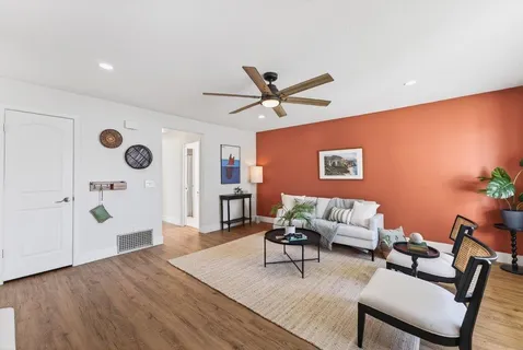 a living room with furniture and wooden floor