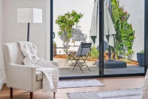 a living room with furniture and a potted plant