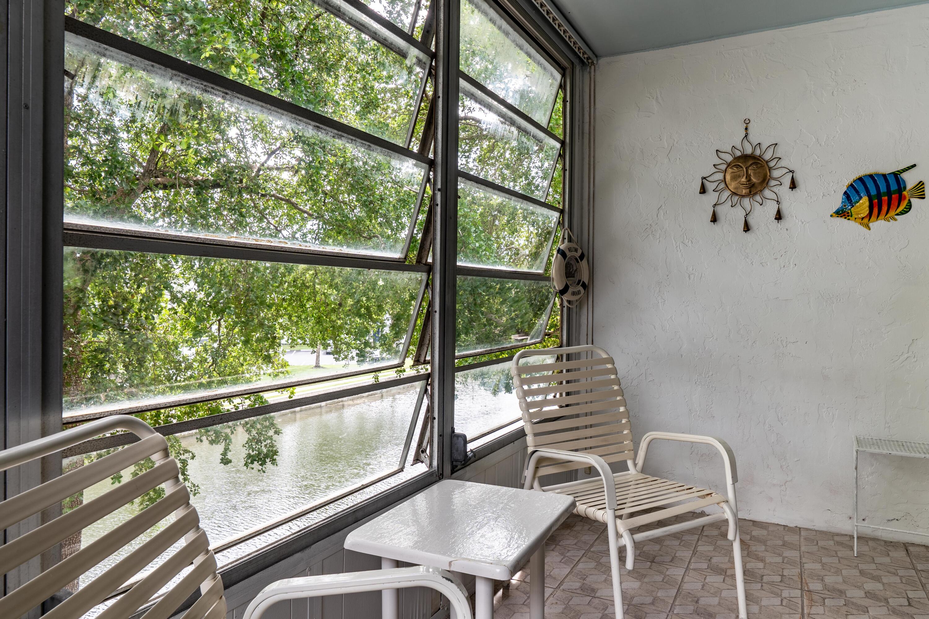 8360 Sands Point Boulevard, Unit G306 Tamarac, FL 33321 - Photo 1 of 13 a view of a dining room with furniture a chandelier and windows
