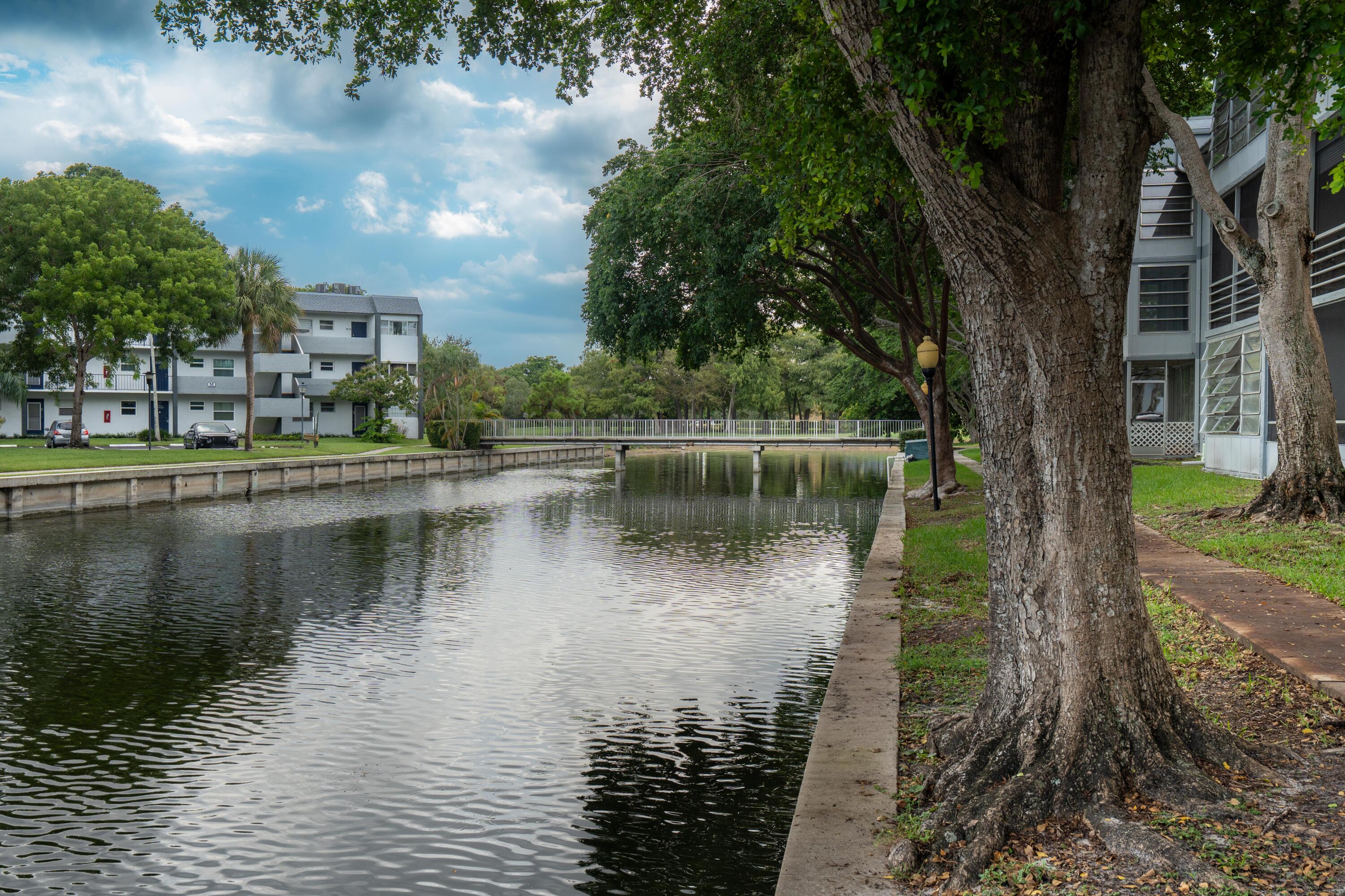 8360 Sands Point Boulevard, Unit G306 Tamarac, FL 33321 - Photo 11 of 13 a view of a large body of water surrounded by trees