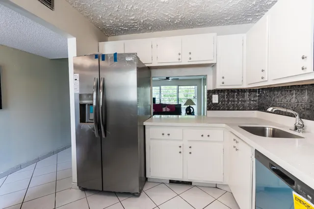 a kitchen with stainless steel appliances granite countertop a refrigerator sink and cabinets