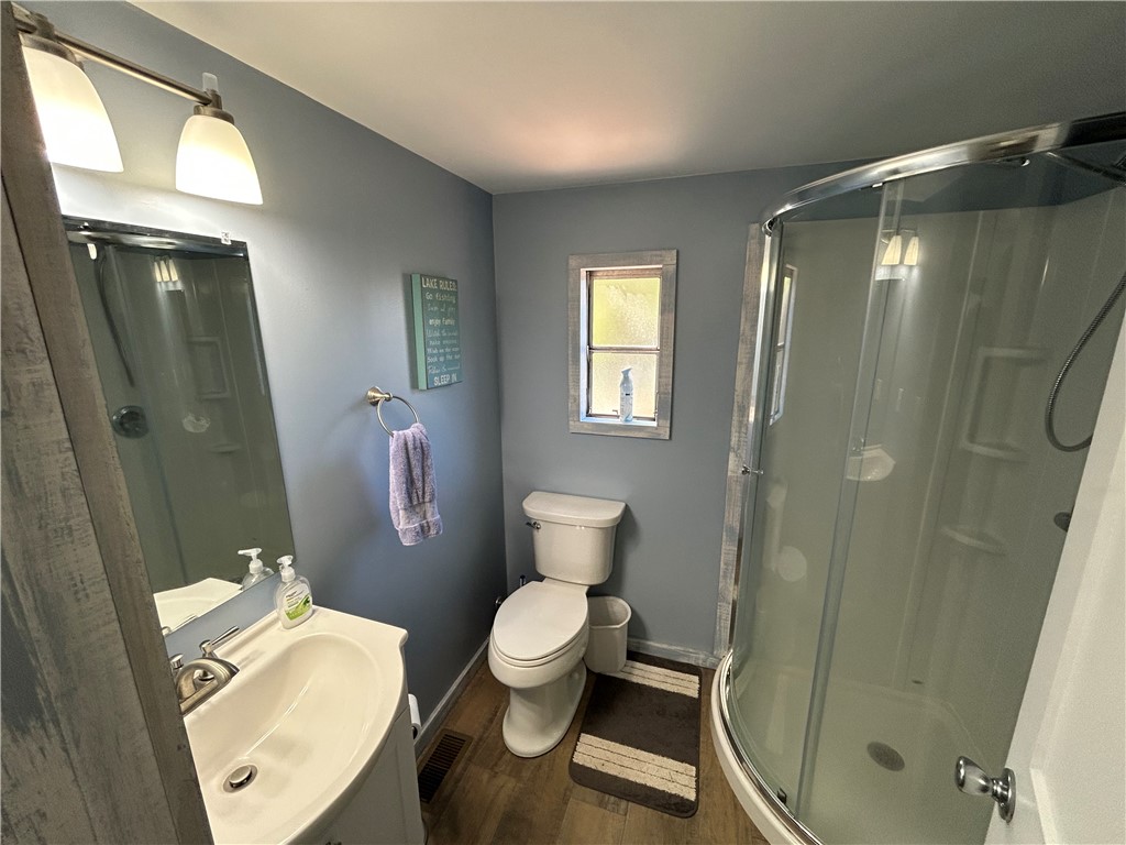 43 Sunset Cove Road Abbeville, SC 29620 - Photo 11 of 41 This functional bathroom features a shower, toilet, and vanity with a well-lit mirror.
