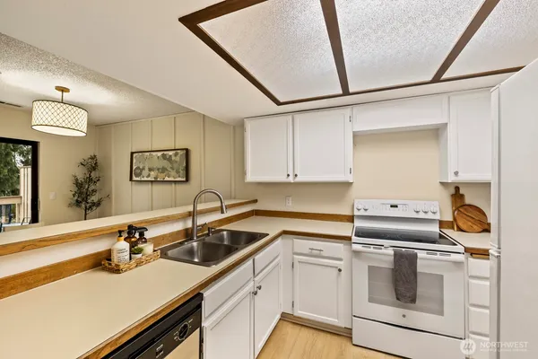 a kitchen that has a sink and a stove