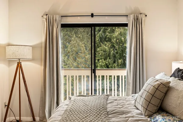 a bedroom with a bed and a large window