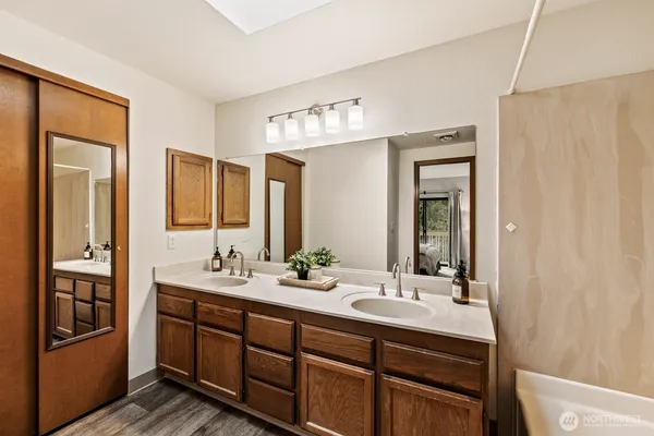 a bathroom with double vanity sinks and a mirror