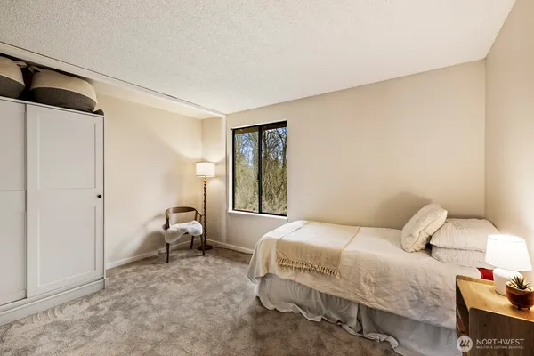 a bedroom with a bed and a window