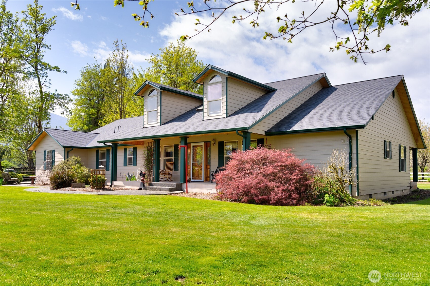 a front view of house with yard and outdoor seating