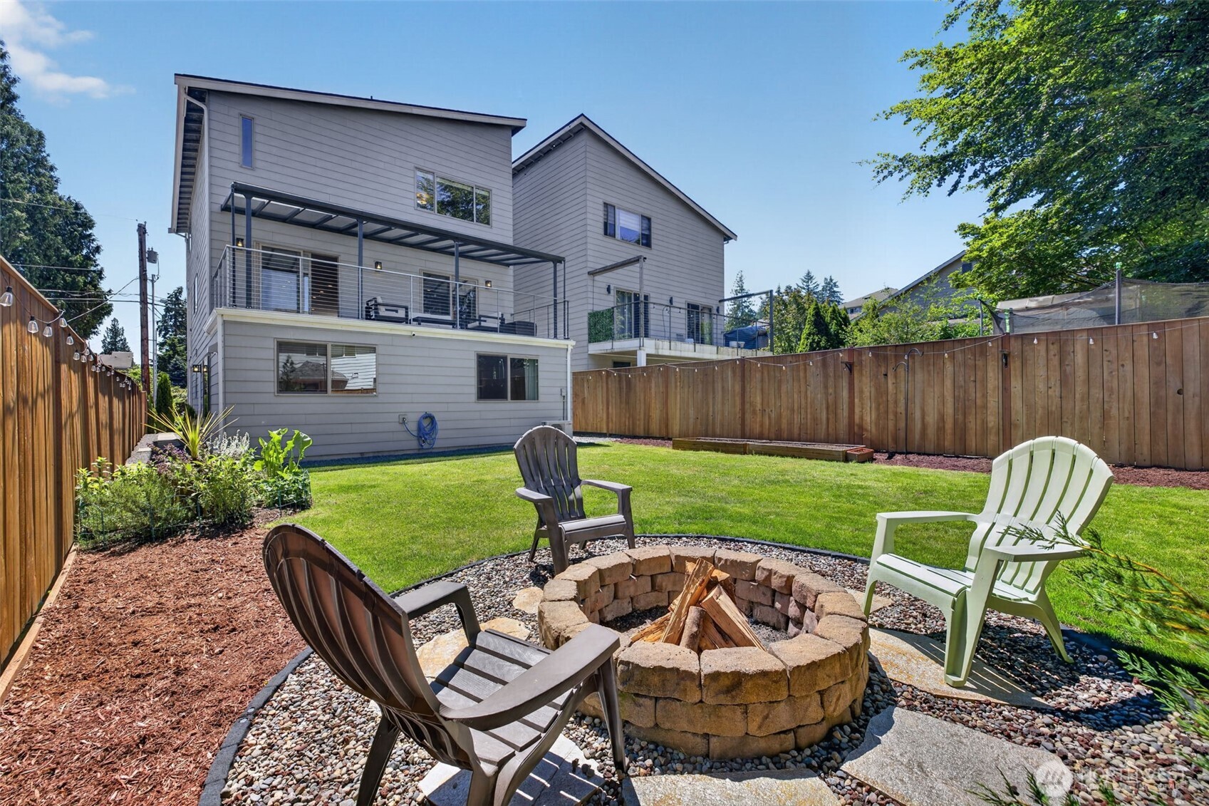 629 Bing Road, Unit B Lynnwood, WA 98036 - Photo 27 of 27 a view of a chair and table in backyard of the house