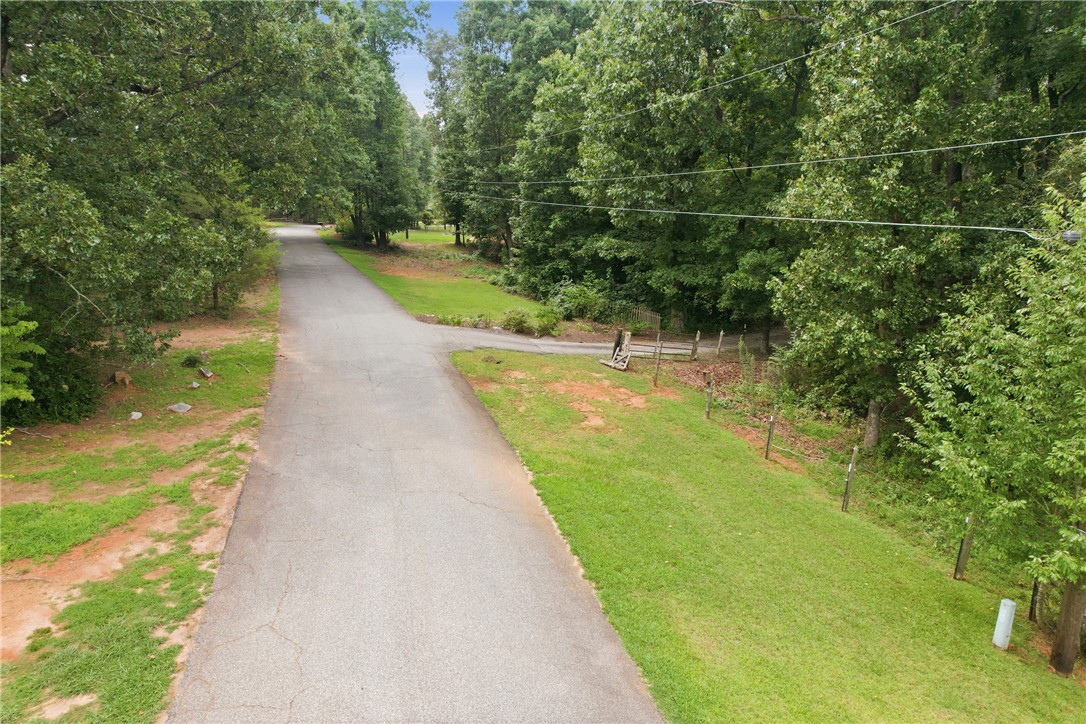 0 Southern Acres Road Anderson, SC 29625 - Photo 2 of 27 A tranquil, tree-lined road offers a private entrance to a verdant lot.