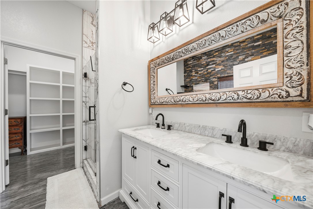 351 Line Camp Loop Spring Branch, TX 78070 - Photo 11 of 27 a bathroom with a sink and a mirror