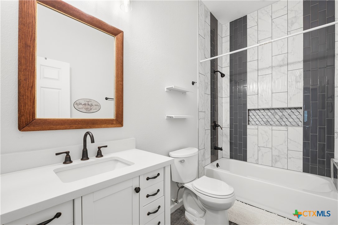 351 Line Camp Loop Spring Branch, TX 78070 - Photo 15 of 27 a bathroom with a sink toilet vanity and shower