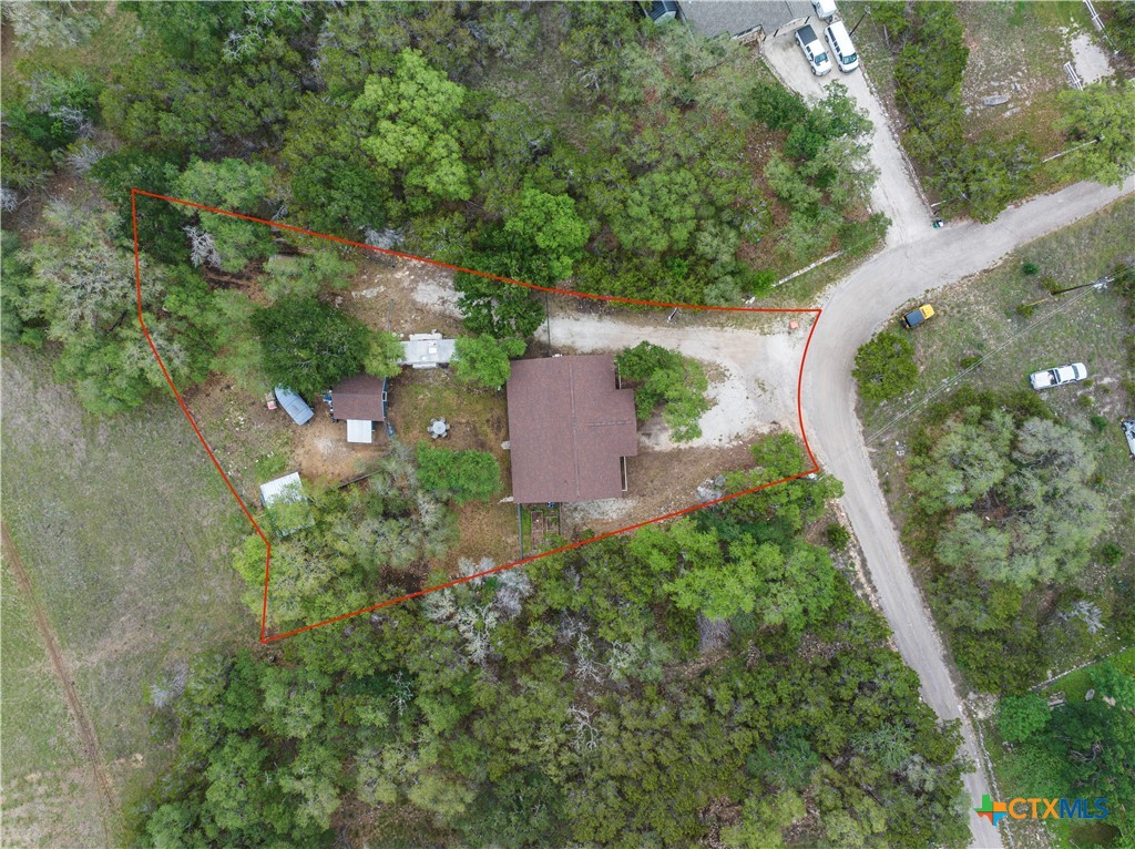 351 Line Camp Loop Spring Branch, TX 78070 - Photo 2 of 27 an aerial view of a house with a yard and trees all around
