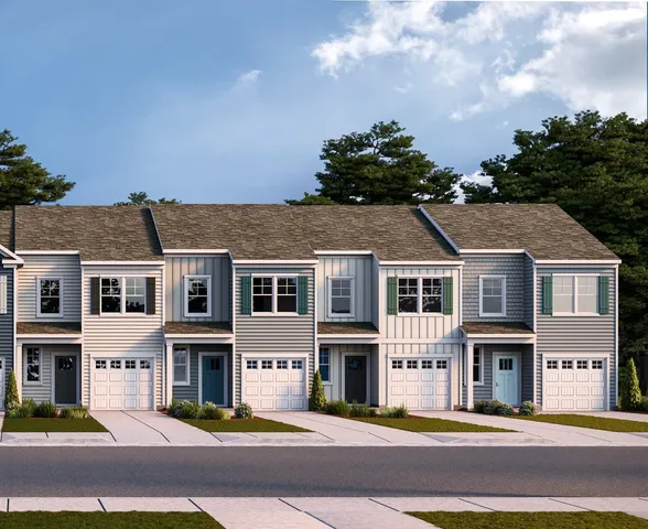 a front view of residential houses with yard