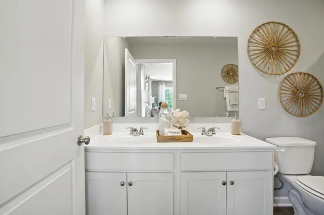 a bedroom with a bed window and a chandelier