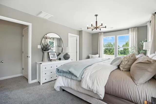 a spacious bedroom with a large bed and a couch