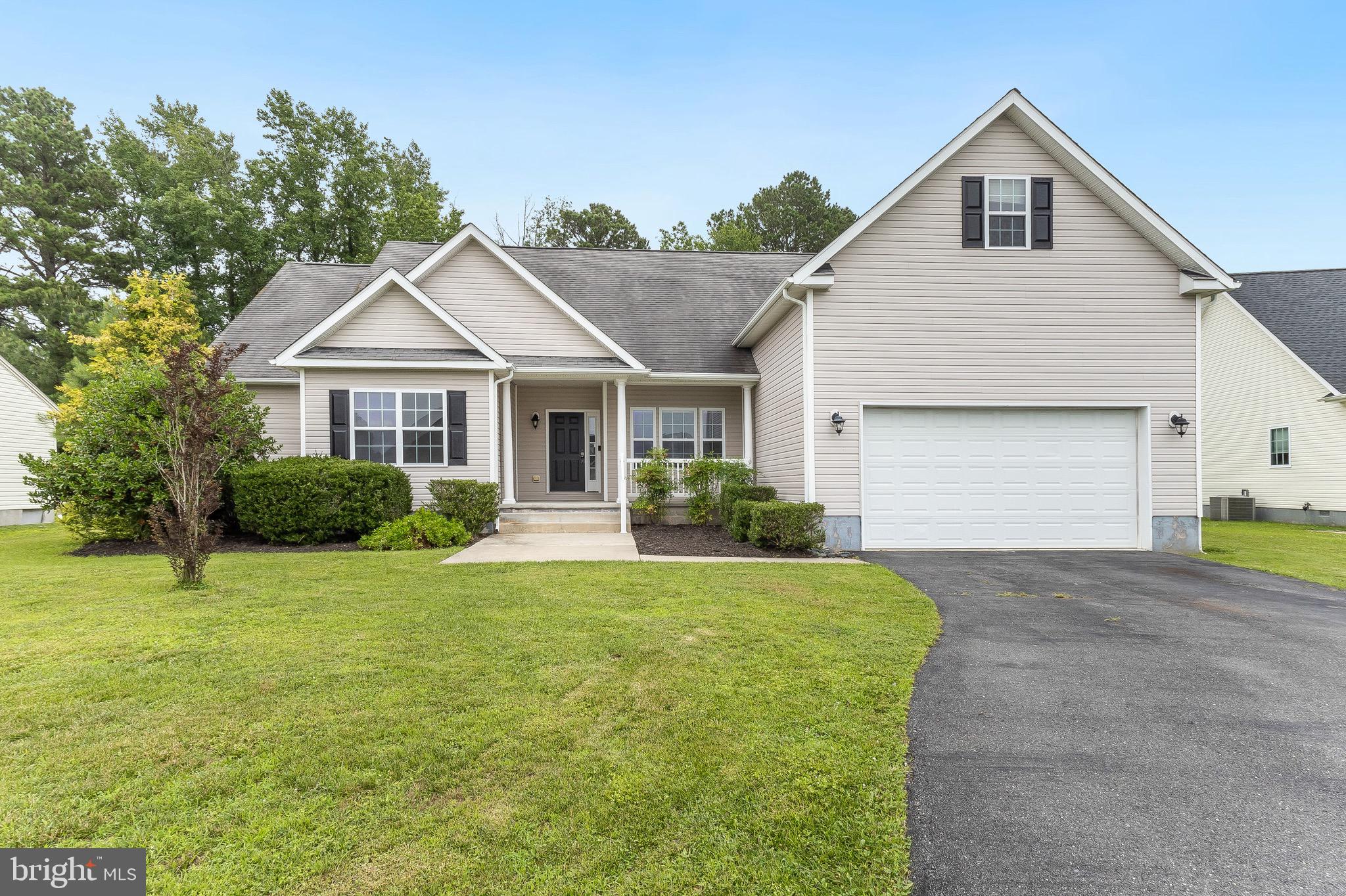 35141 Country Walk Delmar, DE 19940 - Photo 1 of 33 a front view of a house with a yard and garage