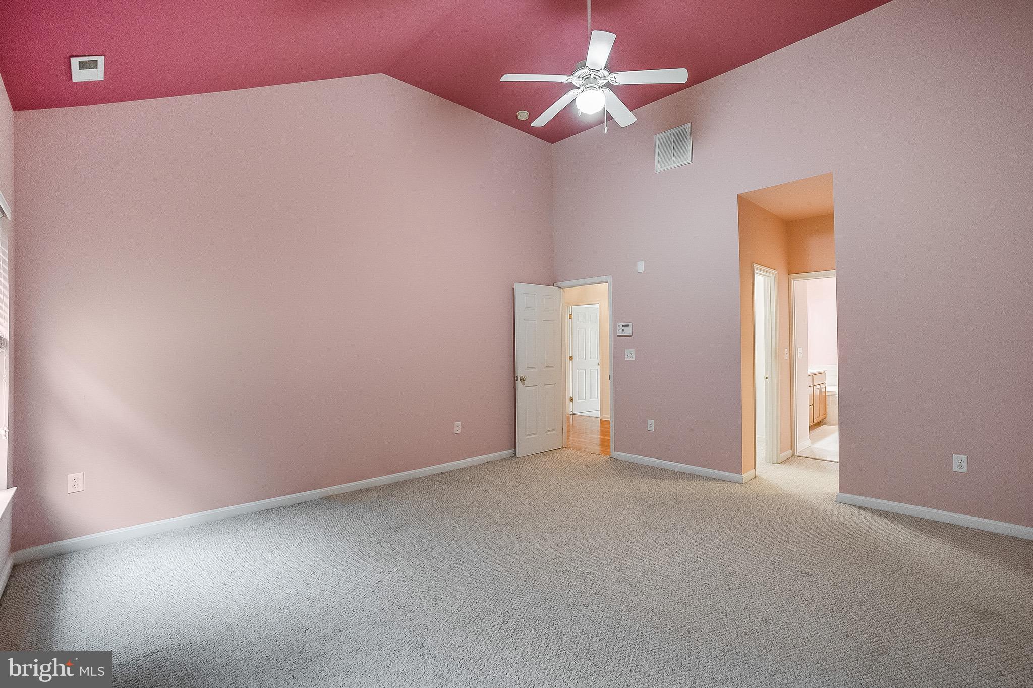 35141 Country Walk Delmar, DE 19940 - Photo 16 of 33 an empty room with a chandelier fan and windows