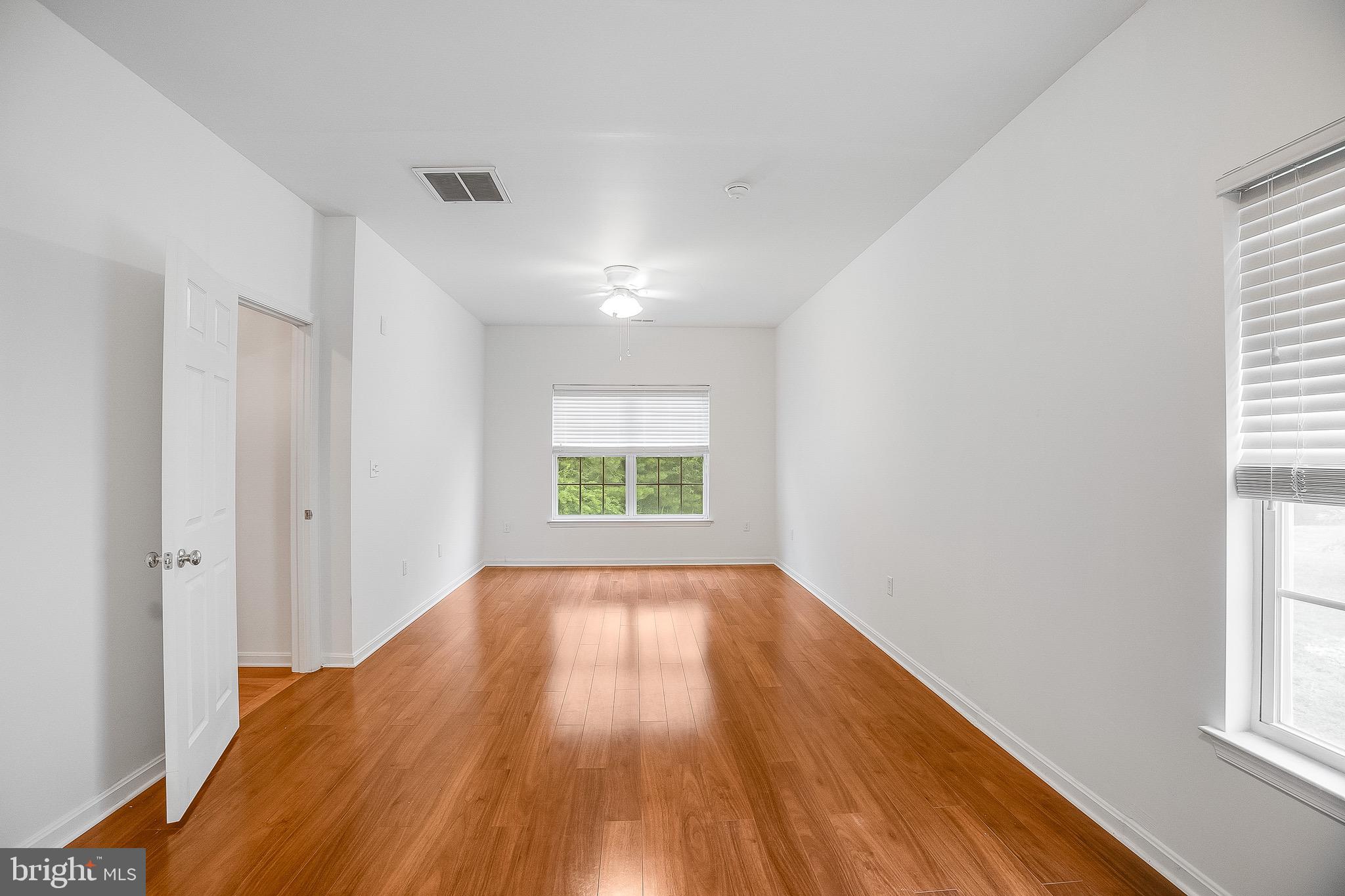 35141 Country Walk Delmar, DE 19940 - Photo 20 of 33 an empty room with wooden floor and windows