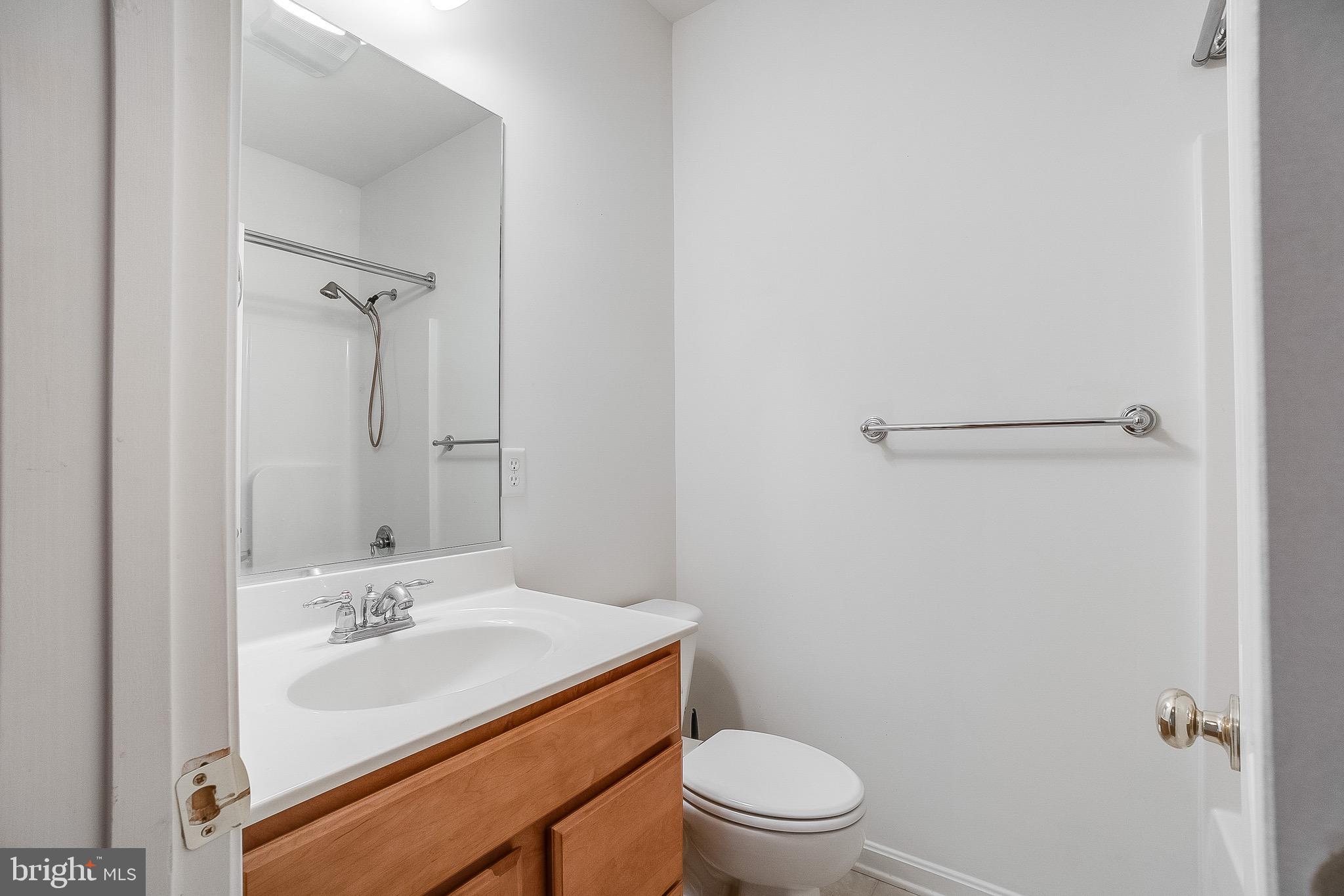 35141 Country Walk Delmar, DE 19940 - Photo 24 of 33 a bathroom with a sink a toilet a mirror and shower