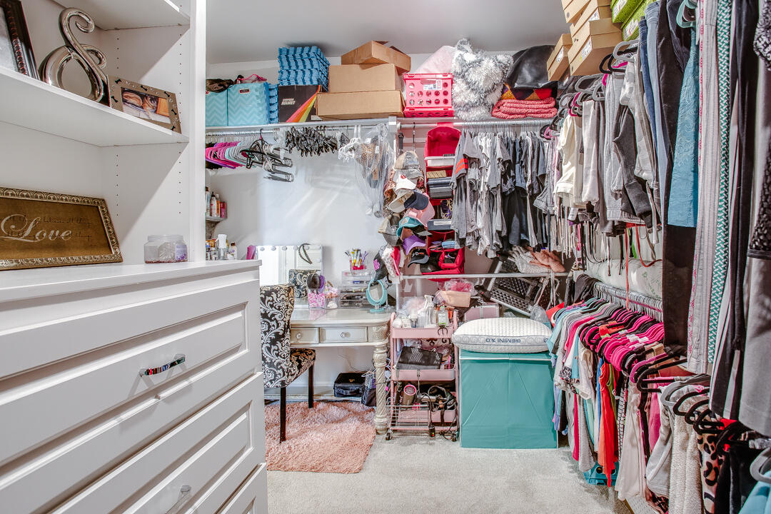 5701 119th Street Lubbock, TX 79424 - Photo 14 of 22 a store room with lots of different colored cloths