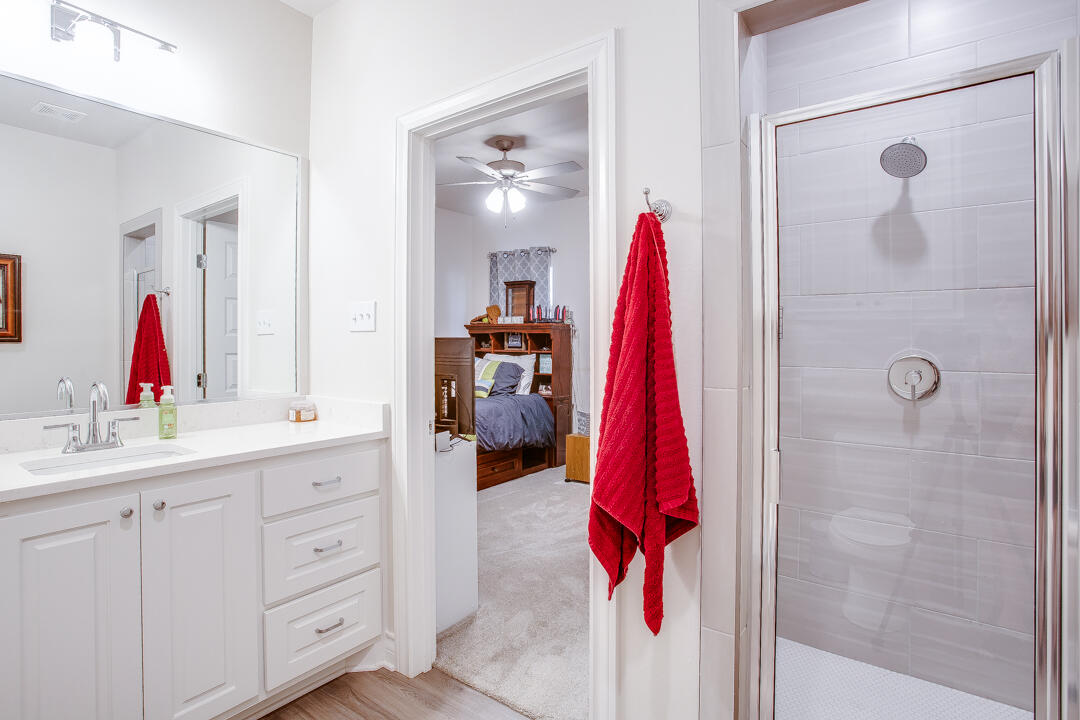5701 119th Street Lubbock, TX 79424 - Photo 18 of 22 a bathroom with a sink vanity and a mirror