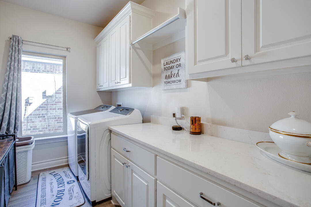 5701 119th Street Lubbock, TX 79424 - Photo 19 of 22 a view of a kitchen with sink and wooden floor
